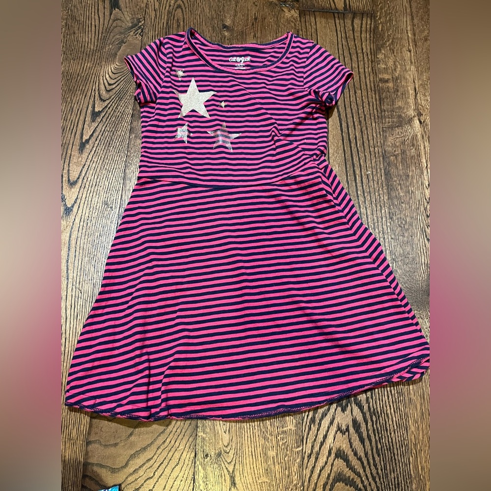 A pink and black striped dress with stars